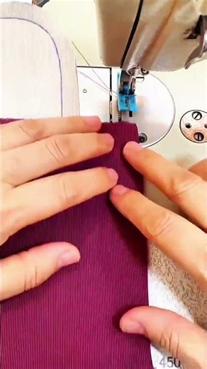 Hands guide fabric sewing machine stitches with precision