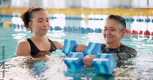 Dumbbell, exercise and happy woman in swimming pool with instructor for mature fitness, health or muscle. Weight, water and aerobics class for training, physical therapy and rehabilitation in lesson