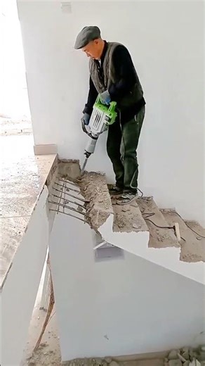 Process of demolishing an old concrete staircase using heavy equipment safely #shorts