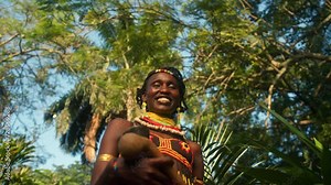 African Woman In Traditional Clothes In The Jungle Of Uganda - Low Angle, Close Up