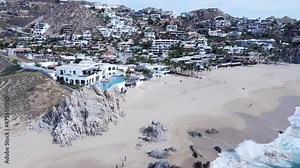 aerial 4k view of luxury homes by the beach in Cabo mexico