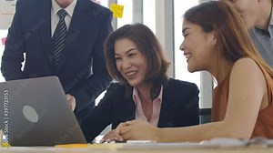 Happy successful asian business team give high five. A group engaged in team-building celebrates good teamwork result achieve corporate goals.