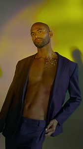 Model in stylish open jacket against colorful backdrop - Free Stock Video