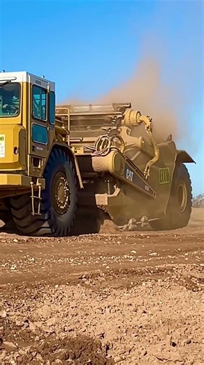 CAT paddle scraper in action. #construction #scrapers #constructionequipment