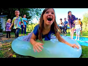 Slow motion belly flops on a Giant Water Balloon! | 6 foot Climb inside balloon filled with water