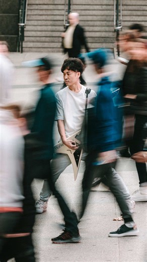 An artistic portrait of a guitarist, captured in natural light with a slow shutter in Toronto. ( Camera Setting ) Camera : Canon EOS R6 Lens : RF70-200mm F2.8 L IS USM Setting : 1/10 , F5.6 , ISO100 Focal length : 100mm