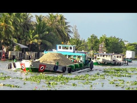 Huge cargo ships navigate the narrow waterway