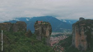 Panorama of Holy Trinity Monastery. Beautiful scenic panoramic view, ancient traditional greek building on the top of huge stone pillar in Meteora,Thessaly, Greece, Europe on a cloudy day.