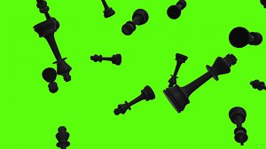 Black chess pieces, king pieces background. Falling black chess pieces over green screen or chroma key. Rain of black chess pieces across the screen.