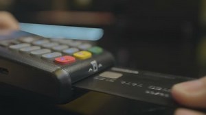 Credit card machine for money transaction. Man hand with credit card swipe through pos terminal and enter pin code. Banking services of electronic money. Financial success and safety.