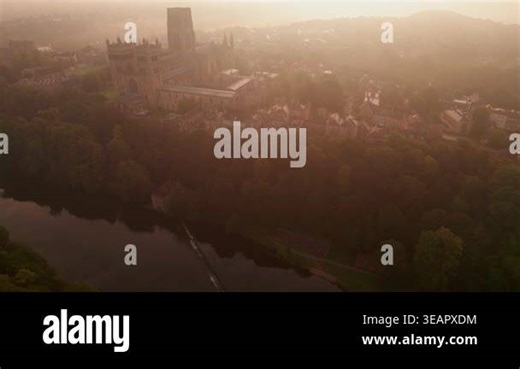 Drone flies slowly at height over weir on River Wear towards Durham Cathedral on a stunning summer dawn Stock Video Footage - Alamy