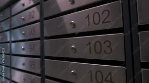 Metal mailboxes with apartment numbers in a multi-story building