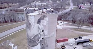 Today's Iowa Road Trip: Fort Dodge Silo Art Iowa's largest mural is on a 110ft grain silo in Fort Dodge, created by artist Guido van Helten. It was created using only a few tones of hand-mixed acrylic and aerosol paints. The images are based on photos of local residents that he met and interviewed. | Iowa Road Trip