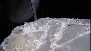 Creation of an ice sculpture in the studio with a chisel and hammer, 4k