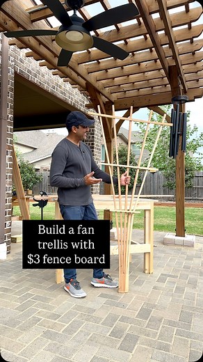 This $3-ish fence picket makes a great DIY trellis. Trim the top (dog ears), mark 6 lines with a rafter square (3/4” each), and leave the last 6” of the board uncut to stake it into the ground. Carefully, cut along the lines with a circular saw, but stop right at the 6” line. Cut the last two off completely: use a strip to make 1-, 2-, and 3-foot crosspieces. Fan out the remaining strips with a clamp. Glue and staple the 3-footer across the top, the 1-footer at the bottom, and the 2-footer in th