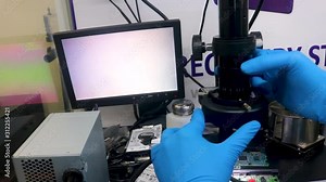 Investigating a broken hard drive with a microscope to find a solution for recovering the data