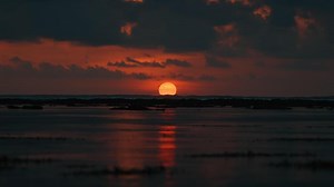 Stunning sunset over ocean waves with clouds