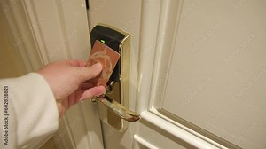 Close up view of opening the door to hotel room, using NFC key card. Luxury modern room corridor. Check in to the apartment. Arriving on trip. High Quality 4k footage.