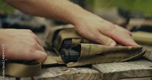 5.56 bullets being grabbed and loaded into a magazine