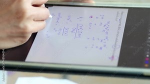 Calculation of chemical formula on tablet, close up view