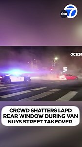 A mob surrounded an LAPD cruiser and broke a rear window after the officer arrived to try to break up a street takeover in Van Nuys. | ABC7