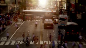 Crowds of people commuting in the city crossing street in rush hour traffic