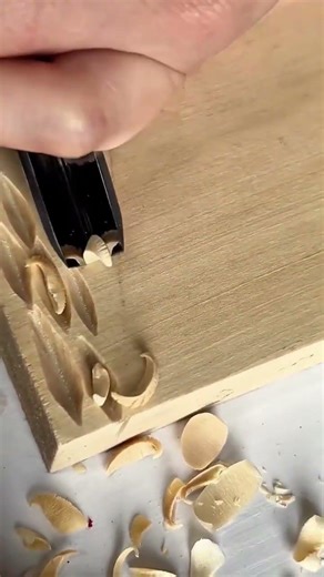 Carving Decorative Patterns on Wood Surfaces Using a V Gouge Chisel for Artistic Woodworking