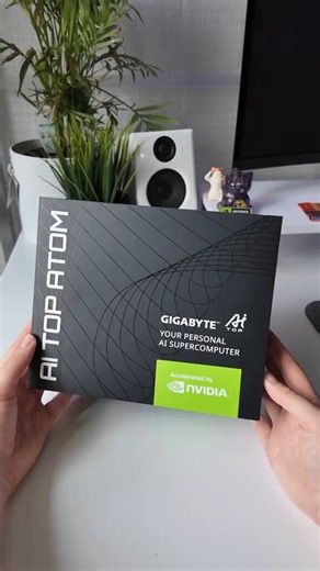 YOUR NEXT AI SERVER MIGHT FIT ON YOUR DESKGIGABYTE AI TOP ATOM looks like a quiet black mini PC, but the box says the real pitch out loud: your personal AI supercomputer, accelerated by NVIDIA. The video keeps it simple, showing the unboxing, the compact chassis, the cooling grille and the ports that make it feel more like a local compute node than a normal desktop box.The interesting part is the contrast. It is small enough to sit next to a monitor, but the whole design is clearly aimed at peop