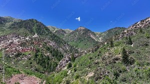 Aerial Mount Nebo Utah rocks peak towards. National Scenic Byway. Steep canyon valley, forest, waterfalls and snow banks. Nature and environment. Beautiful natural environment.