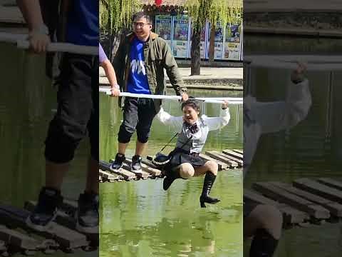 Wet heels boots and short skirts on suspension bridgefall into water