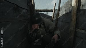 Slow motion shot of Red Army soldier running along frontline trench and hiding from grenade explosion