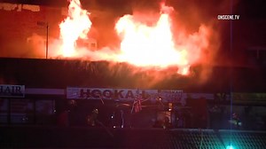 Firefighters battle strip mall blaze threatening East Hollywood apartments