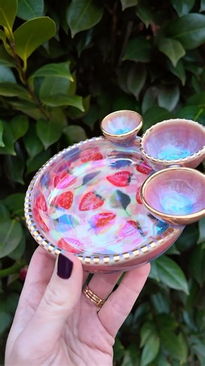 Love in Pottery on Instagram: "Shanna (@diverse.earth) is a ceramic artist based in Raleigh, North Carolina, known for blending playful design with earthy charm. Her handmade pottery layers color, texture, and that extra something that turns the everyday into art. Shanna showcases her dreamy process for crafting a strawberry-themed picnic tray—pressing a pink checkerboard pattern into clay, adding juicy fruit transfers, and finishing with iridescent glaze and gold-tipped bowls. It’s functional p