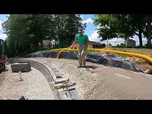 Installing a retaining wall with versa lok blocks. Using engcon tilt rotator and mecalac.