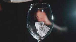 Ice cubes falling into a glass - Free Stock Video