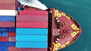 Cargo container ship carrying container and running out international container port customs shipyard sea port concept smart logistic service. Portrait video Container Ship.