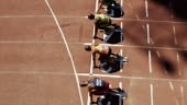 High angle view of male sprinters waiting at starting blocks. Then...