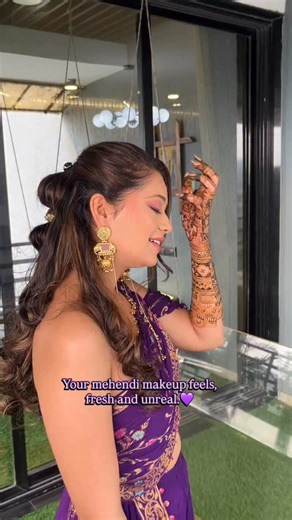 Rutvi Shah | Surat Makeup Artist on Instagram: "Designed this mehendi look for Jeel keeping the outdoor function in mind . A lightweight matte base, purple tones to complement the outfit, and anti-tarnish bands for a flawless hairstyle finish💜 . Makeup :- @rutvi.makeupartist_ Inframe :- @jeel_chahwala @knotsospecial._ . [Makeup , mahendi bride , explore , wedding , wedding content , bridal makeup , surat makeup artist , trending looks , open hairstyle , mahendi hair , open hairstyle , purple ey