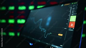Stock market candles and information of exchange with data of price on the tablet screen. Financial indexes change up and down over time. Concept of trading cryptocurrency assets and bitcoin