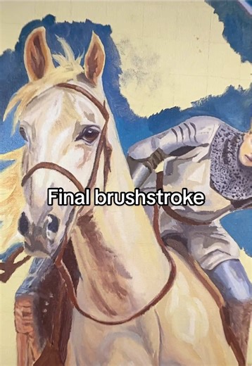 My last brushstroke on the horse. In this video, I dip my paintbrush into brown oil paint and add the final touch onto a horse in my painting. This painting depicts Joan of Arc riding heroically.