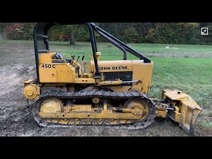 John Deere 450C pushing small pines down!!