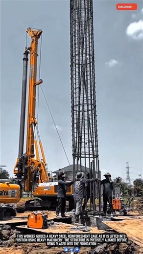 This Worker Carefully Lifts and Positions a Massive Rebar Column for Foundation Work