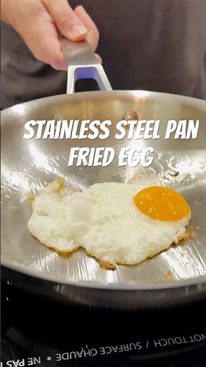 Slow-motion fried egg on a stainless steel pan with 1 tablespoon olive oil