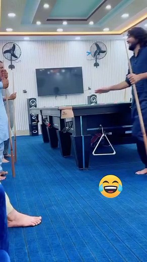 Playful Moments with Friends at Pool Table