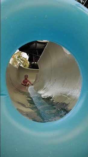 Ultimate Fun: Kids Splashing and Sliding in the Pool – The Joy of Water Slide Adventures