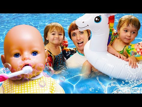 Kids pretend to play with baby dolls. Baby Annabell morning routine. Feeding time. Swimming pool fun