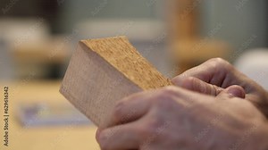 Closeup video of wood carving process of a human figure with a knife