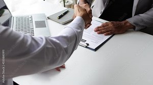Job applicant submits resume during job interview with company manager.