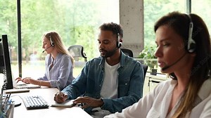 Male representative call center agent in wireless headset helping client, operator working in customer support service