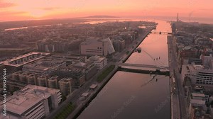Aerial dawn view of Dublin City, Sunrise in the Irish capital of Dublin creates a golden hue over the city. Shot in 4K.